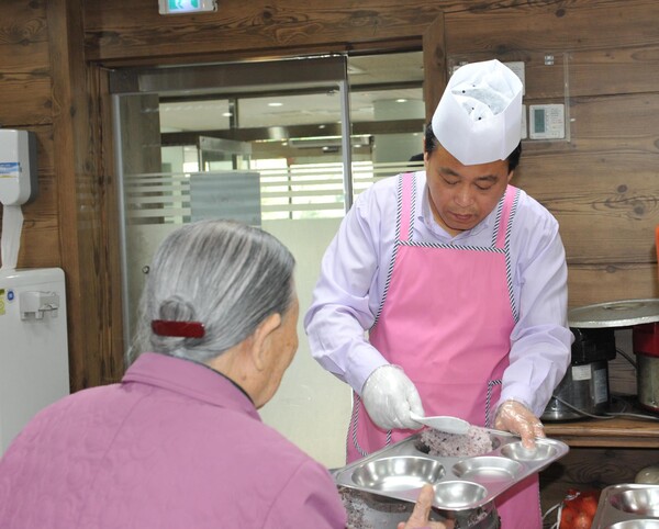 강 전 후보가 구의회 의장 시절 신목종합사회복지관 경로식당에서 무료급식 봉사를 하고 있다. 사진=양천구의회